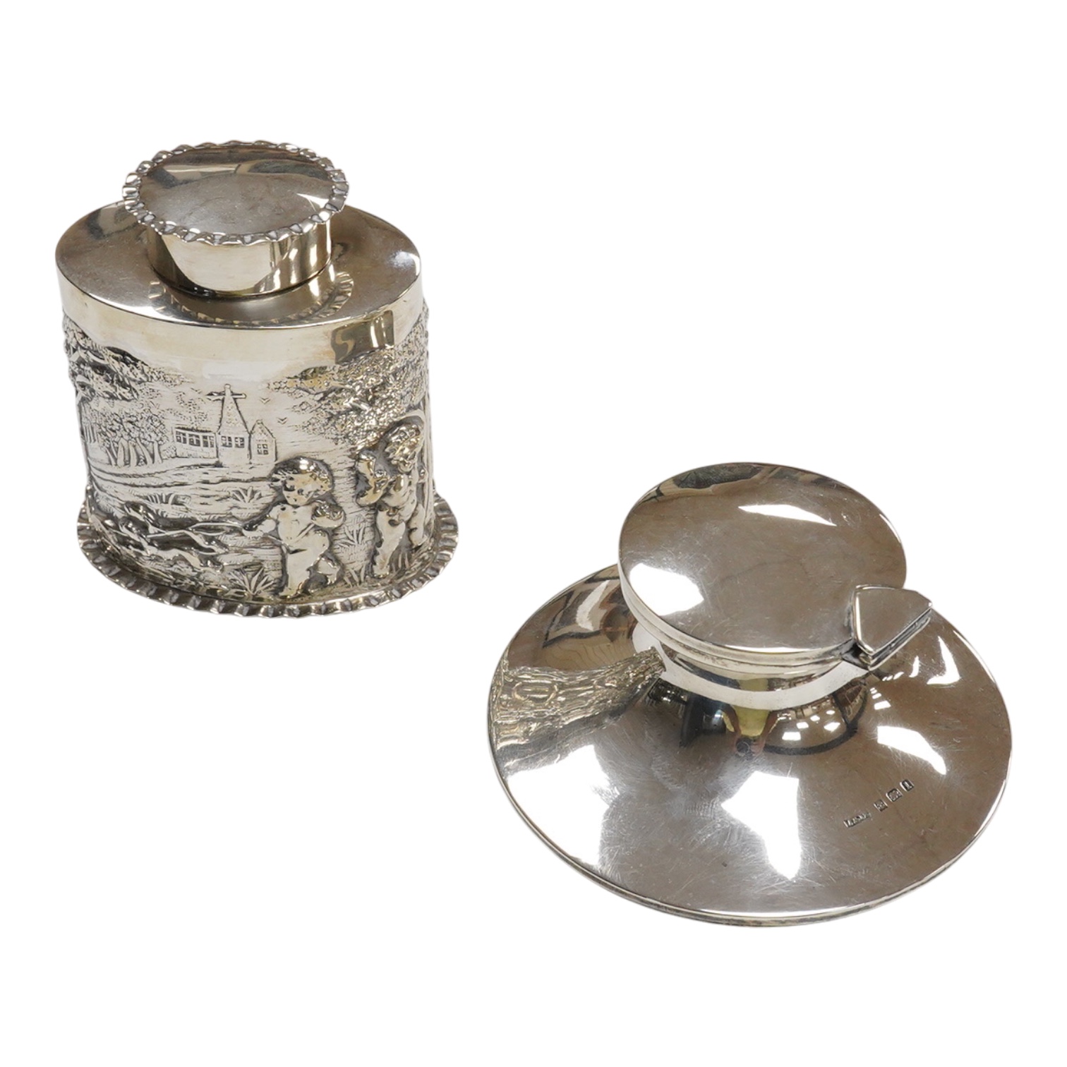 A late Victorian repousse silver oval tea caddy, by Nathan & Hayes, Chester, 1896, height 75mm, together with a George V silver mounted capstan inkwell.